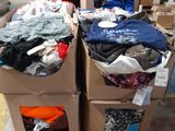 two boxes of clothes sitting on top of each other in a warehouse