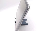 a tablet computer sitting on a stand on a white surface