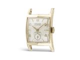 une image représentant une montre en or avec un cadran blanc