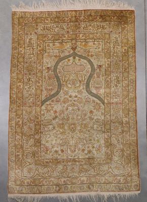 an antique persian rug with a gold border and a white background