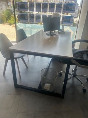 a desk with two computer monitors on it in a room