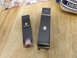 a close up of two lipsticks on a wooden table