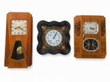 three clocks on a white background with a white wall behind them