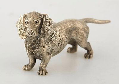 silver dog figurine on a white background