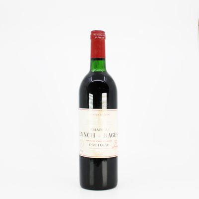 a bottle of wine sitting next to a glass of wine