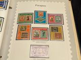 an open book with stamps on it sitting on a table
