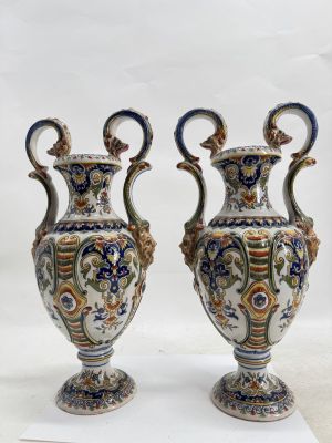 two vases sitting on top of a white surface next to each other