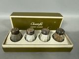 three salt and pepper shakers in a box on a table