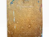 a piece of cardboard with paint on it on a white surface