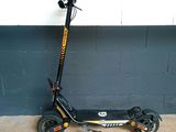 a scooter that is parked in front of a wall