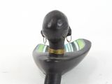 a black figurine with a green and yellow striped scarf on it