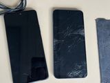 three cell phones sitting next to each other on a table
