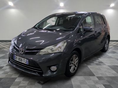 the grey toyota sienna is parked on a checkered tile floor