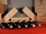 many bottles of wine sitting on a red table cloth