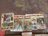 a lot of comic books sitting on a table