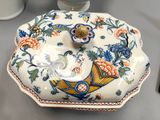a plate with a bird design on it on a table