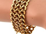 a close up of a person ' s hand wearing a gold chain bracelet