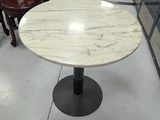 a table with a marble top in a store