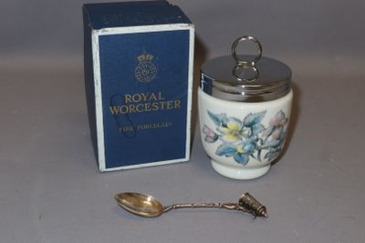 a small jar with a spoon in it next to a box