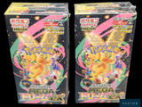 two boxes of pokemon trading cards are shown on a black background