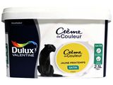 a tub of cream with a cat sitting on top of it