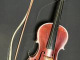 an old violin with a bow and a bow rest on a table