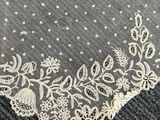 a close up of a piece of lace on a piece of cloth