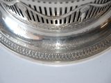 a close up of a silver plate with a clock on it