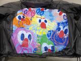 a picture of a jacket that has a picture of a clown on it
