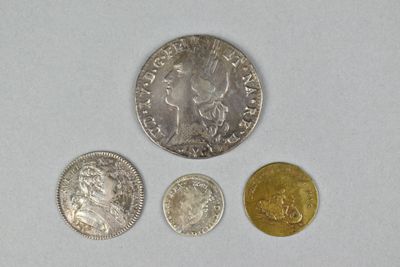 three different coins sitting on top of a table next to each other