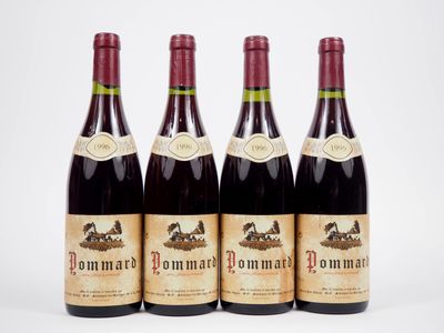 three bottles of wine are lined up on a white surface