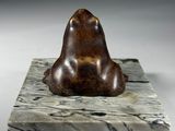 marble sculpture of a bear on a marble base on a white background