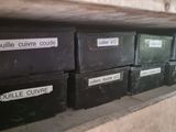 many black boxes with labels on them on a shelf