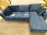 a blue couch with a chaise on it in a room
