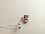 a close up of a ring with a purple stone on it