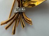 a gold brooch with a bunch of flowers on it