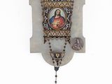 an image of a rosary hanging on a wall with a picture of jesus