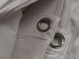 a close up of a pair of metal rings on a white jacket