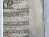 an old book with writing on it sitting on a white surface