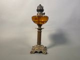 an old fashioned oil lamp with a crown on top of it