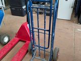 a blue hand truck and a red hand truck in a warehouse