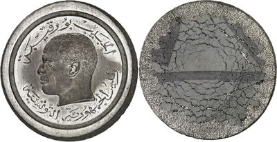 a close up of a coin on a white background with a picture of a man