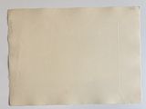 a close up of a piece of paper on a white surface