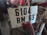 a sign that says 61104 on it in front of a tractor