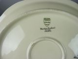 a white plate with a green emblem on it