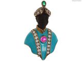 une image représentant une broche bleue et dorée ornée d'une pierre rose