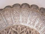 a silver plate with a decorative design on it