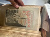 a person that is holding a book in a box