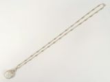 collier en argent avec un pendentif en diamant sur une chaîne, sur fond blanc