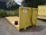 a yellow dumpster sitting in the middle of a parking lot